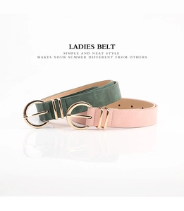 Close-up of green nubuck and pink leather belts with round gold alloy pin buckles