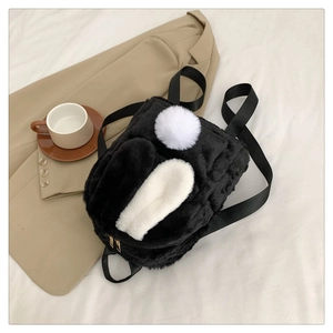 Close-up of soft faux fur rabbit ears and gold zipper detail on mini backpack