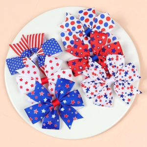 Detailed flat lay of 6 red white and blue American flag themed fabric bow hair clips
