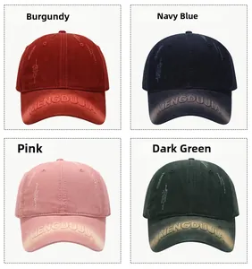 Detail of embroidered letters on four washed vintage baseball caps in various colors