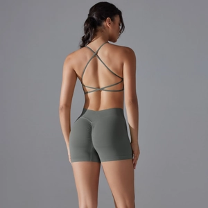 Detail view of seamless cross-back sports bra and high waist scrunch shorts in olive green