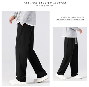Detail of men's black straight leg casual pants featuring white adjustable drawstrings