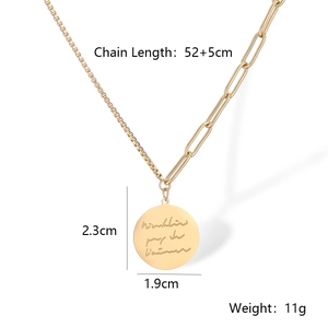 Detailed spec view of a gold layered necklace with asymmetrical chain and round pendant