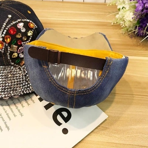 Detail of blue denim baseball cap showing premium stitching and leather strap back