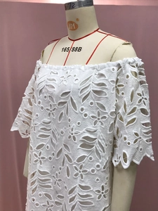 Detailansicht der weißen floralen Hohlspitze mit elegantem Wellenrand-Texturdesign