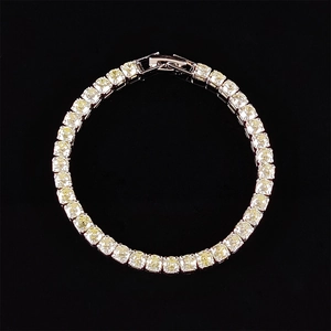 Overhead view of a tennis bracelet with yellow cubic zirconia in silver four-prong setting