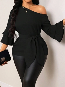 Detail of ruffle cuffs and waist tie on women's off-shoulder denim style blouse