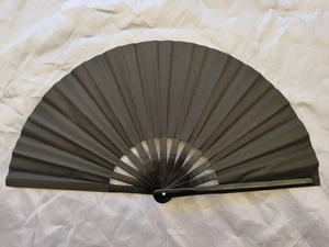 Top view of a fully opened 33cm black Kung Fu folding fan with dark bamboo ribs