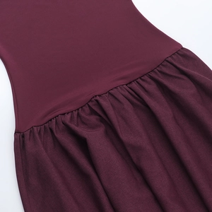 Macro shot of burgundy strapless dress fabric with detailed gathering and stitch texture