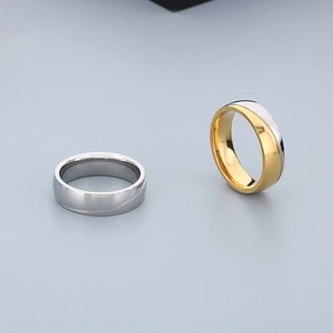Macro detail of minimalist polished stainless steel rings in silver and gold-tone finish