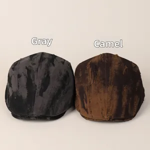 Detail view of distressed tie-dye ivy caps in grey and camel with retro torn fabric