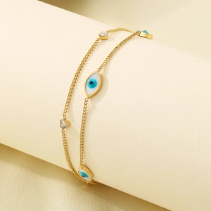Golden double-layer anklet with blue evil eye charms and sparkling zircon accents