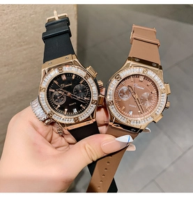 Detail of luxury quartz watches with silicone straps, calendar display and crystal bezel