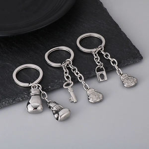 Three creative stainless steel keychains featuring boxing gloves and fortune bag pendants