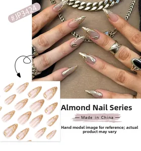Close-up of almond shaped press-on nails with 3D gold fluid design on nude base