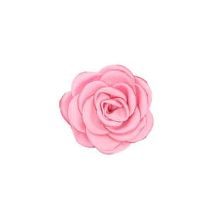 Macro detail of a pink handmade satin camellia flower with layered petals for DIY crafts