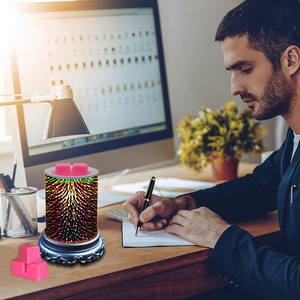 3D fireworks glass electric wax melt warmer with soy wax melts on an office desk