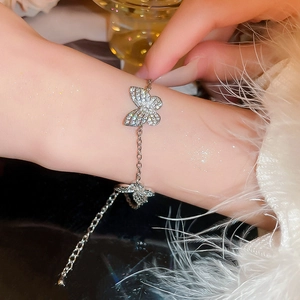 Elegant silver butterfly bracelet with sparkling rhinestones worn on a model's wrist