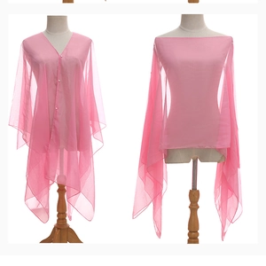 Pink sheer shawl wrap showing pearl buckle detail and elegant off-shoulder styling