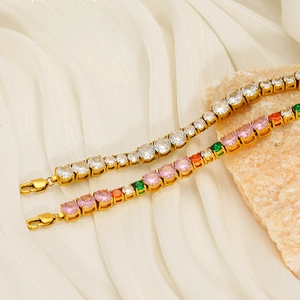 Detail of gold tennis bracelets with multicolor and white cubic zirconia on a stone