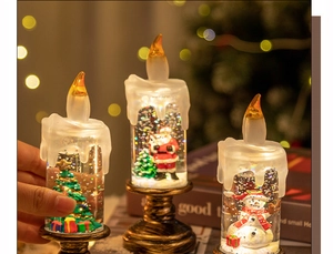 Close-up of three decorative Christmas snow globe candles with Santa, Snowman, and Tree figurines