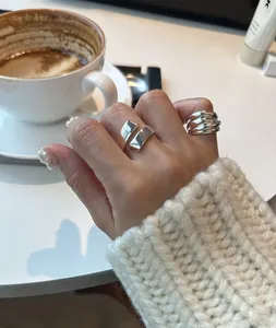 Close-up of minimalist 925 sterling silver layered and geometric rings for women