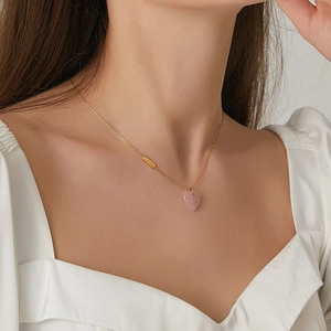 Minimalist 18K gold plated titanium steel necklace with pink quartz heart pendant on model