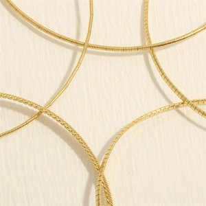 Macro shot of 18K gold-plated snake bone chain with high-quality metallic luster details