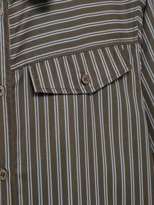 Detail of striped poplin shirt with olive green fabric and a buttoned chest pocket