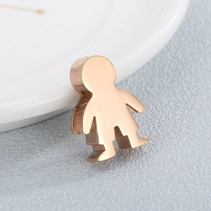 Macro detail of rose gold stainless steel humanoid pendant with polished mirror finish