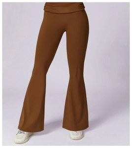 Detail view of high-waisted brown flare yoga pants with pleated waistband and elastic fabric