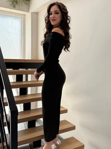 Detail of elegant black off-shoulder maxi dress with long sleeves and slim fit design
