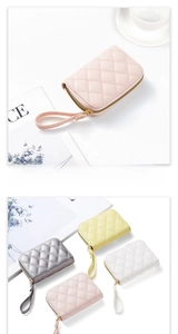Detail of quilted leather cardholder featuring diamond stitching and smooth zipper closure