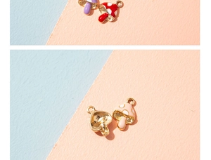 Detail of colorful enamel mushroom charms with gold-plated alloy bases for DIY jewelry