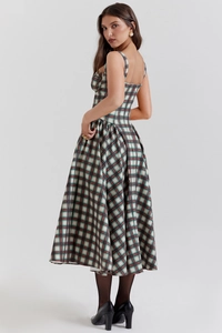 Detail of the back design on a vintage plaid dress with adjustable straps and wide hem