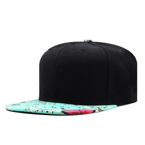 Detail of flat brim snapback featuring vintage floral print and black cotton crown