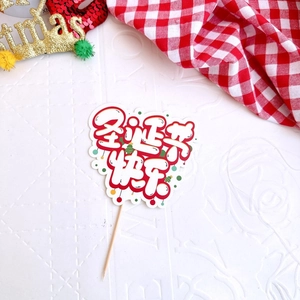Macro view of a paper Merry Christmas cake topper with festive holiday patterns