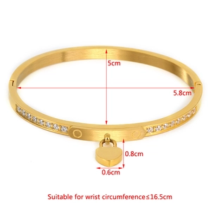 Gold-tone heart bangle in titanium steel with double rows of pavé crystals and size guide