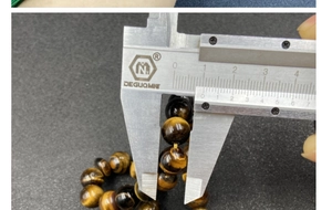 Detailed view of 10mm tiger eye gemstone bead measured with a digital caliper