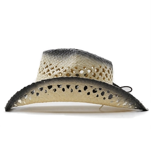 Detail of raffia straw cowboy hat featuring hollow weave texture and black gradient finish