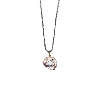 Macro detail of Venus pendant necklace with blue enamel and gold finish on white background
