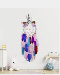Detail of unicorn dream catcher with colorful feathers and silver horn in a cozy room