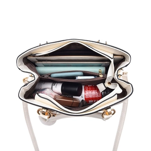 Large beige tote bag with black trim showing spacious interior and multiple compartments