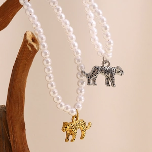18K gold plated hollow tiger pendant pearl necklace on wooden display stand