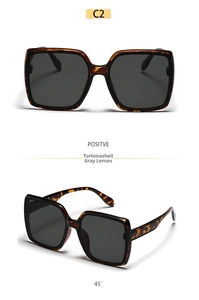Detail view of tortoiseshell square sunglasses with grey lenses in front and 45-degree angle