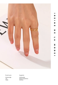 Close-up of gold-plated hollow chain ring on finger with polished stainless steel finish