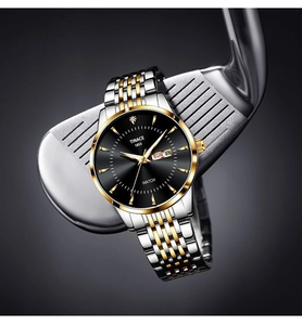 Macro shot of black dial watch with day-date display and two-tone metal strap