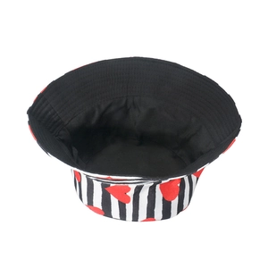 Black and white striped sun hat with red heart pattern shown from a top-down view