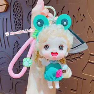 Cute doll keychain with frog hat and articulated limbs on a silicone strap