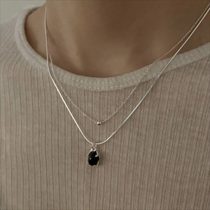 Minimalist silver double-layered necklace featuring black agate pendant on a snake chain
